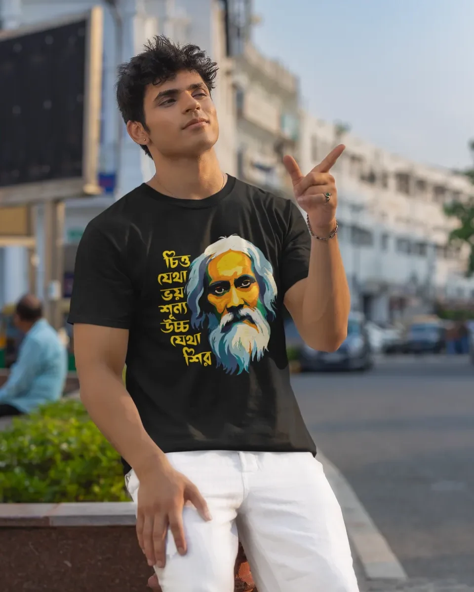 A model wearing a Black unisex t-shirt from BongStreet. The Bengali design shows an animated face of Rabindranath Tagore and the Bengali text says - Chitto jetha bhoyshunyo, Uccho jetha shir.